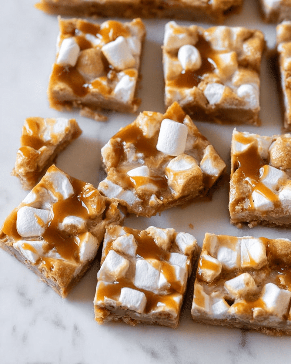 The image shows several square pieces of a dessert arranged closely on a white marbled surface. Each piece has a golden brown base layer that looks crispy and slightly uneven in texture. On top, there is a layer of melted white marshmallows, which are soft and slightly puffy, scattered unevenly. Over the marshmallows, there is a light drizzle of caramel sauce that adds a glossy finish and darker amber color contrast. The edges of the squares are sharp and clean, showing they were neatly cut. photo taken with an iphone --ar 4:5 --v 7