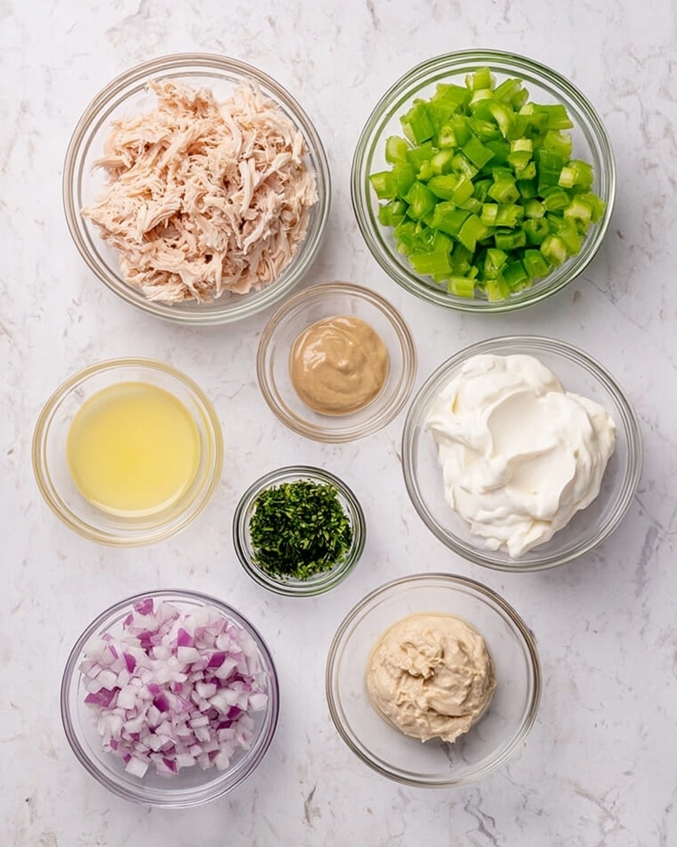 The image shows seven clear glass bowls of different sizes arranged on a white marbled surface. Starting from the top left, the first bowl contains shredded light pink cooked chicken pieces. To its right, there is a bowl filled with small green chopped celery pieces. Next to it, on the right, is a bowl with thick white cream. Below the cream, there is a small bowl with finely chopped dark green herbs. Moving left from the herbs, there is a medium bowl of pale yellow lemon juice. Above it, to the left, there is a small bowl of light brown creamy mustard. Finally, on the bottom left corner is a small bowl filled with finely chopped light purple onions. The bowls are evenly spaced and the colors and textures stand out clearly on the white marbled surface. photo taken with an iphone --ar 4:5 --v 7