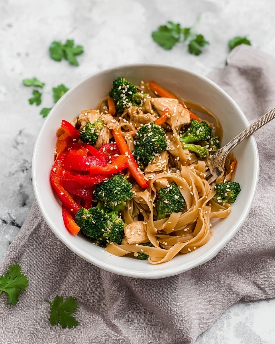 A white bowl filled with three layers of food: the bottom layer is light brown wide noodles with a smooth texture, the middle layer has pieces of light brown cooked chicken mixed with orange thin carrot sticks, and the top layer shows bright green broccoli florets and bright red bell pepper chunks all sprinkled with small white sesame seeds. A silver fork is resting on the side inside the bowl. The bowl is placed on a light gray cloth on a white marbled surface with a few green cilantro leaves scattered around. Photo taken with an iphone --ar 4:5 --v 7