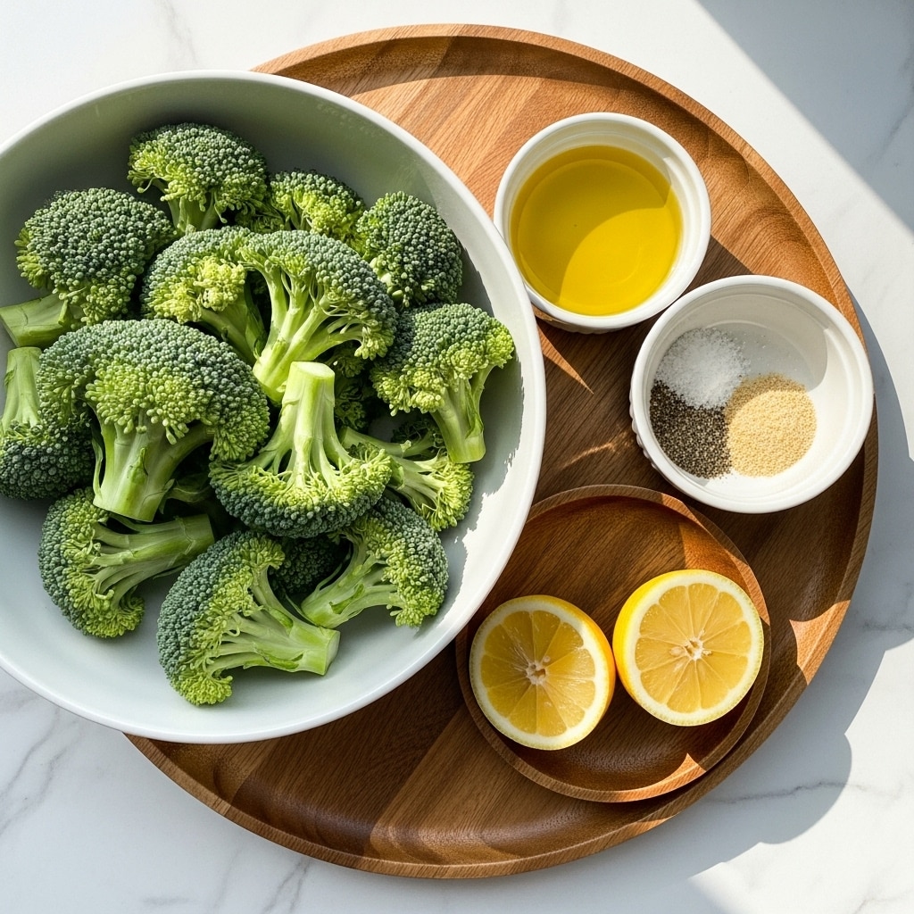 A large white bowl filled with fresh bright green broccoli florets sits on the left side of a round wooden tray. On the right side of the tray, there is a small white bowl with golden yellow olive oil inside and next to it a white bowl containing a mix of salt, black pepper, and light brown garlic powder. Beside these bowls, a small round wooden dish holds two lemon halves showing their juicy pale yellow insides. The whole setup is placed on a white marbled surface with natural sunlight casting soft shadows. photo taken with an iphone --ar 4:5 --v 7