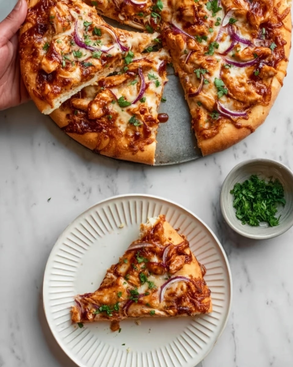 A close-up image shows a round pizza with a golden-brown crust on a white marbled surface. The pizza has a thick layer of melted cheese that is slightly browned in spots, with visible swirls of reddish-brown barbecue sauce spread unevenly. On top, there are sliced pieces of chicken and thin red onion strips, creating a mix of orange, purple, and white colors. Chopped green herbs are sprinkled over the pizza, adding a fresh touch. One slice is served on a white plate with ridged edges, placed below the pizza, and a small bowl of chopped green herbs sits next to the plate. A woman’s hand holds the pizza with two fingers. Photo taken with an iphone --ar 4:5 --v 7