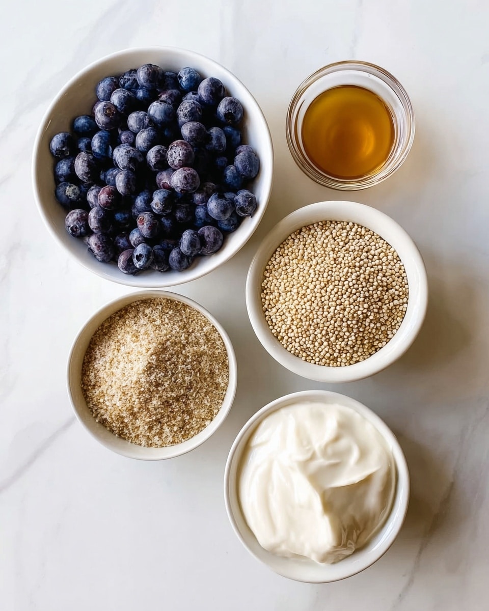The image shows five white bowls placed on a white marbled surface, each holding a different ingredient. The top left bowl is filled with plump, dark blueberries, showing a mix of deep blue and purple hues with a smooth texture. To the right is a small bowl containing light amber-colored liquid. Below the blueberries is another bowl filled with a coarse, light brown powder, giving a grainy texture. To the right of it is a bigger bowl holding a pile of small, round, beige-colored quinoa grains, filling the bowl almost to the top. At the bottom right, a bowl contains thick, white cream with a smooth and soft texture. Photo taken with an iphone --ar 4:5 --v 7