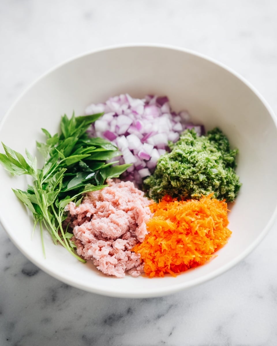 A white bowl holds five separate piles of ingredients, arranged in a circle. One pile consists of finely chopped light purple onions at the upper back. To its right, there is a pile of grated green vegetable with a leafy texture. Below that, to the lower right, is a heap of bright orange grated carrot. On the lower left, there is a pile of pink minced meat. To its left and slightly above, there is a bunch of fresh green herbs with flat leaves. The bowl sits on a white marbled surface. photo taken with an iphone --ar 4:5 --v 7