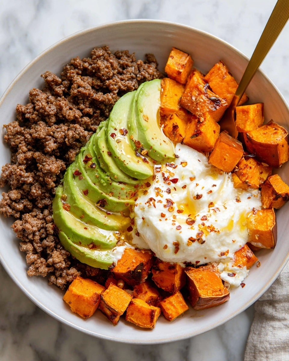 A white bowl holds four main layers arranged side by side: browned ground meat in crumbly small chunks on the left, bright orange roasted sweet potato cubes in the bottom right with slightly charred edges, smooth sliced avocado in the center with a drizzle of honey on top, and a fluffy white cottage cheese dollop in the top right corner sprinkled with red pepper flakes and honey. A golden spoon peeks out from the right side of the bowl. The bowl sits on a white marbled surface. photo taken with an iphone --ar 4:5 --v 7