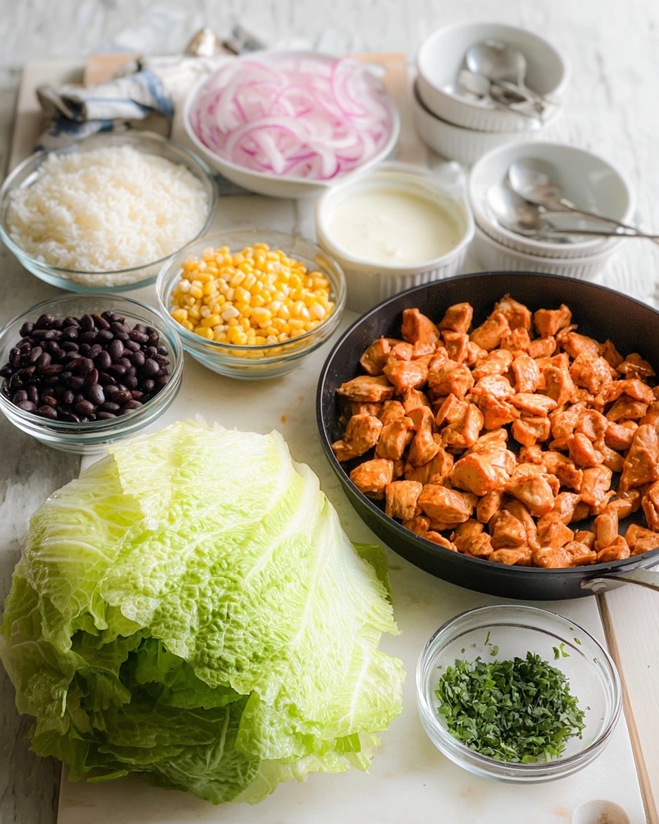 The image shows a food preparation setup with several ingredients placed on a white marbled surface: a large black pan filled with small chunks of cooked orange-colored chicken pieces sits on the right side; in front of the pan is a fresh, whole head of green romaine lettuce with a crisp texture; to the left of the lettuce, three small clear glass bowls contain bright yellow corn kernels, shiny black beans, and pickled light pink onions respectively; behind these, a medium-sized clear glass bowl holds fluffy white cooked rice; next to the rice is a small white bowl filled with a creamy white sauce; on the far right, a small clear glass bowl has chopped green herbs; in the background, two stacked white ceramic bowls contain spoons. Photo taken with an iphone --ar 4:5 --v 7