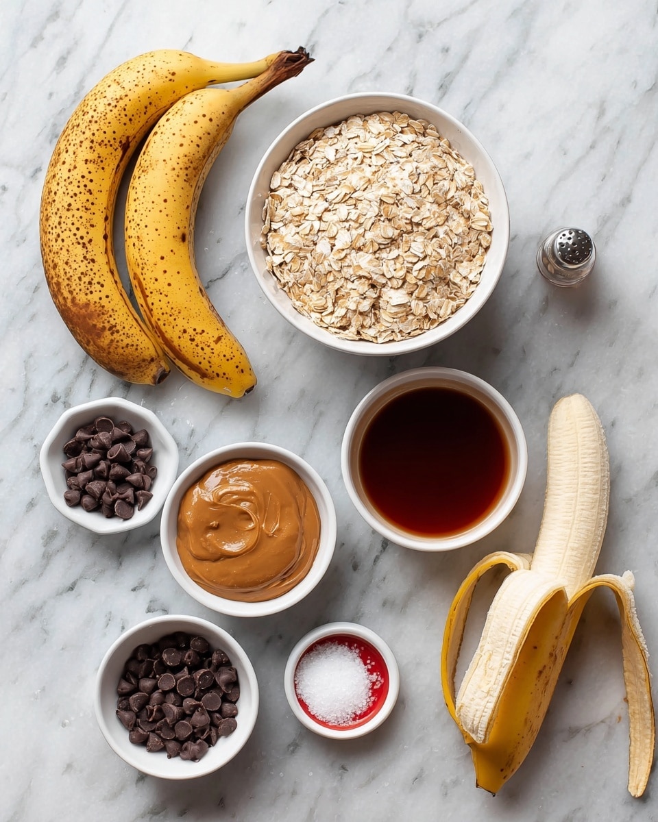 The image shows six ingredients arranged neatly on a white marbled surface. On the left, two ripe bananas with brown spots are placed one above the other. To the right of the bananas, a small white bowl filled with smooth peanut butter sits near the bottom center. Above it, there is a large white bowl full of light brown rolled oats. Further right, a peeled banana with its peel hanging open lies diagonally across the surface. Below this, a small white bowl holds dark brown chocolate chips. Above the chocolate chips, a small white bowl contains a dark red-brown liquid, likely vanilla extract. Near the center, a small white bowl with a red rim holds a white powdery ingredient, possibly baking soda or baking powder. A few chocolate chips and a salt shaker appear scattered around, adding texture to the layout. The photo taken with an iphone --ar 4:5 --v 7
