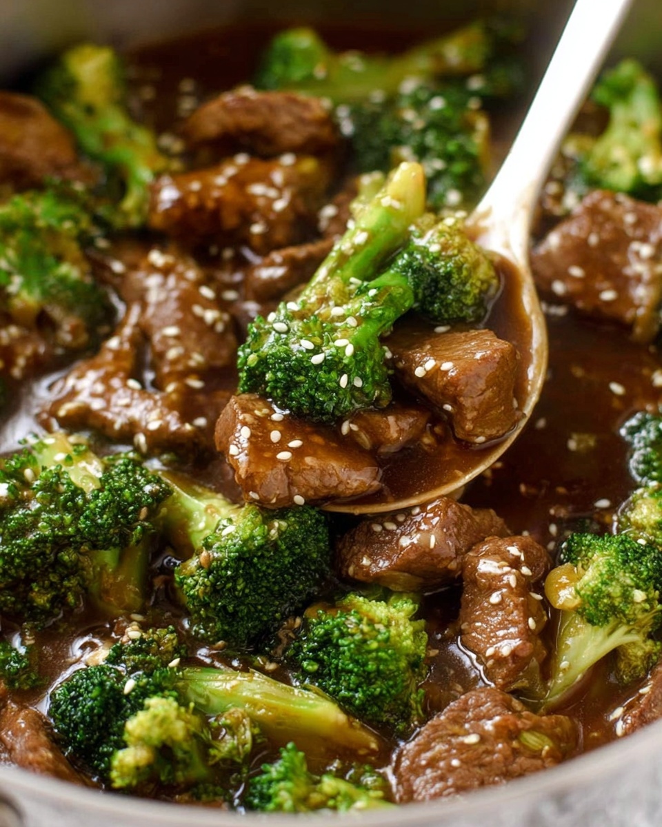 The image shows a close-up of a dish with cooked pieces of brown meat mixed with bright green broccoli florets. The meat and broccoli are coated in a shiny brown sauce, and there are white sesame seeds sprinkled on top, adding texture. A white spoon is scooping the mixture from a pot, showing the thick sauce covering each piece. The background is a white marbled texture. photo taken with an iphone --ar 4:5 --v 7