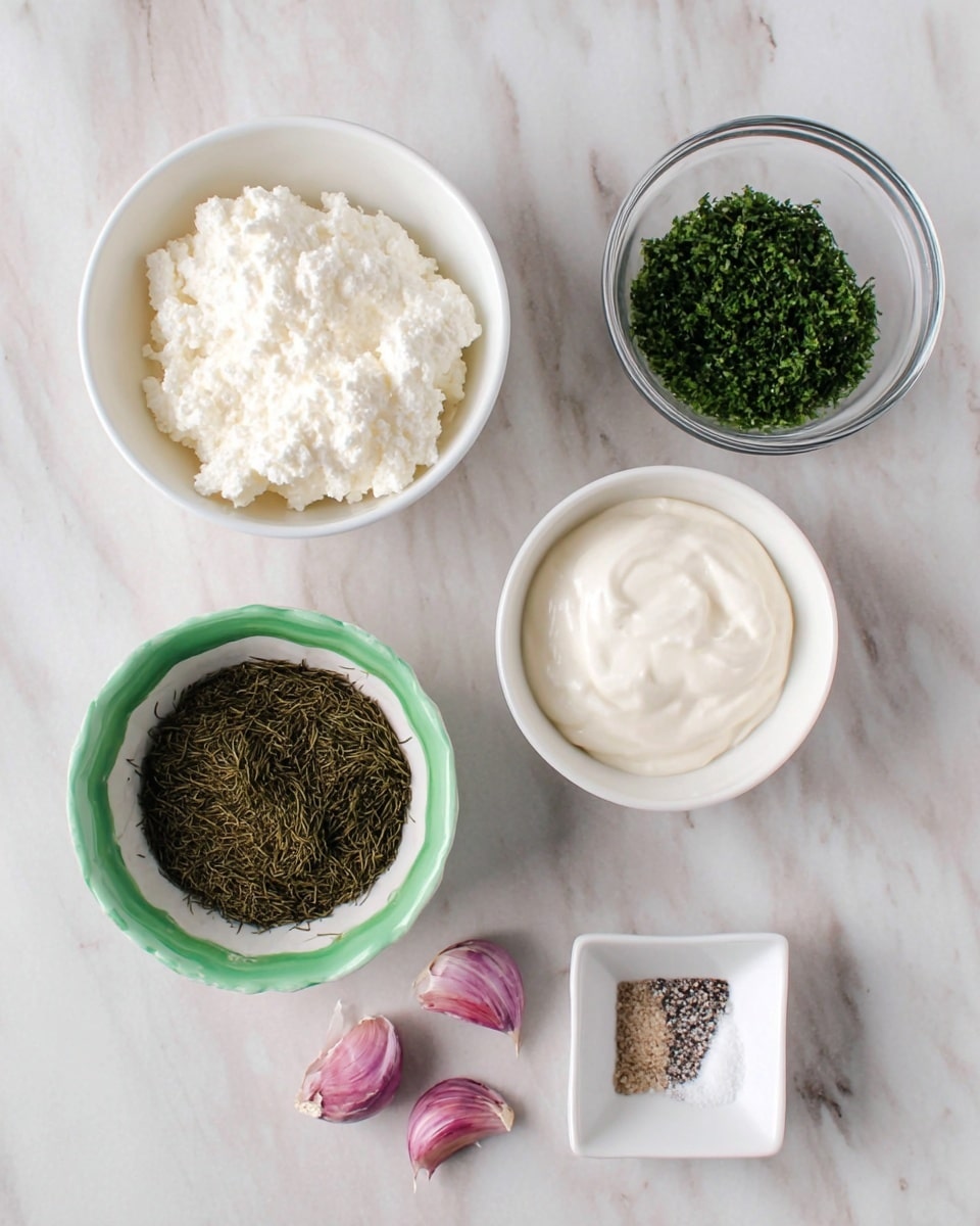 There are five bowls and two garlic cloves on a white marbled surface. The top left bowl is white and filled with white cottage cheese with a lumpy texture. To its right is a white bowl with smooth, white yogurt. Next to it on the right is a clear glass bowl with finely chopped green herbs. Below the bowls, on the left, is a green and white bowl filled with dark green dried dill. To the right of it is a small white square bowl holding white salt and black pepper side by side. Two small garlic cloves with purple skin are placed below the bowls. Photo taken with an iphone --ar 4:5 --v 7