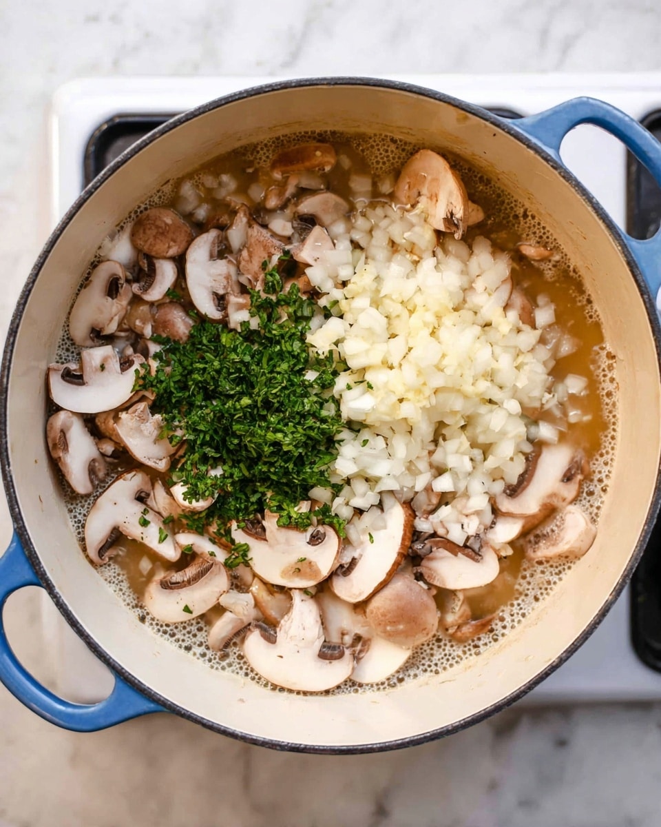 In a white pot with blue handles, there is a mix of sliced mushrooms with light brown and creamy white colors, filling most of the pot. On top of the mushrooms, there are three distinct piles: finely diced white onions, chopped green herbs, and a small heap of minced garlic. The ingredients sit in a light bubbling liquid, showing the start of cooking. The pot is on a stove, and the surface around has a white marbled texture. photo taken with an iphone --ar 4:5 --v 7
