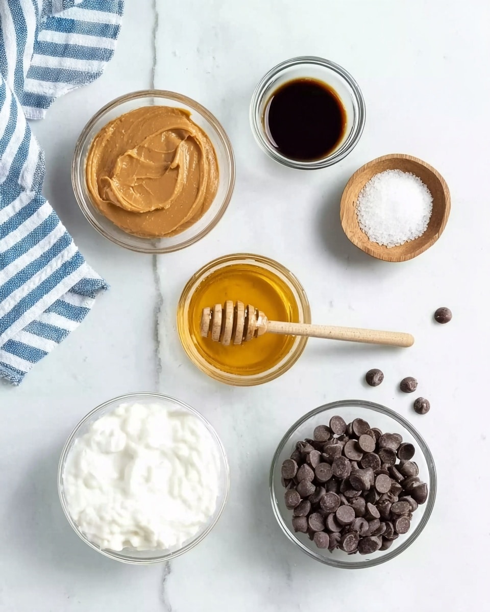 The image shows six small bowls and a few scattered chocolate chips arranged on a white marbled surface. At the top left, there is a small glass bowl filled with smooth peanut butter. To its right, a small glass bowl containing dark syrup is placed. Below these, a small wooden bowl holds white granulated salt. Next to the salt and more centered, a glass bowl with golden honey and a wooden honey dipper resting on the rim is visible. At the bottom left, a white bowl is filled with thick white yogurt. Finally, on the bottom right, there is a glass bowl full of dark chocolate chips with some chips scattered around it. A striped blue and white cloth is partially in view on the left side. Photo taken with an iphone --ar 4:5 --v 7