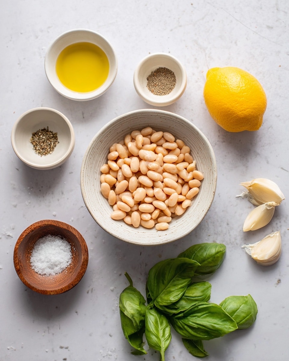 A white bowl filled with light beige beans is centered on a white marbled surface. Around it are several small white bowls and wooden bowls holding different ingredients: a small white bowl with golden oil, a small wooden bowl with ground pepper, a small white bowl with two peeled garlic cloves, a small wooden bowl filled with coarse salt, a halved bright yellow lemon, and fresh green basil leaves resting on the surface. The scene is simple and clean, with soft natural light, photo taken with an iphone --ar 4:5 --v 7