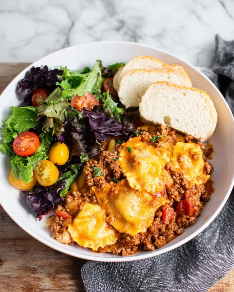 A white bowl holds a layered meal with three main parts: at the bottom right, there is a serving of ravioli covered in a thick sauce made of brown ground meat and red tomato bits, all topped with melted yellow and light orange cheese. On the left side of the bowl, there is a fresh salad made of dark green and purple leafy greens mixed with small round yellow and red cherry tomatoes. At the top right edge of the bowl, two thick slices of a white, soft bread are placed. The bowl sits on a white marbled surface, and a gray cloth is visible in the background. Photo taken with an iphone --ar 4:5 --v 7