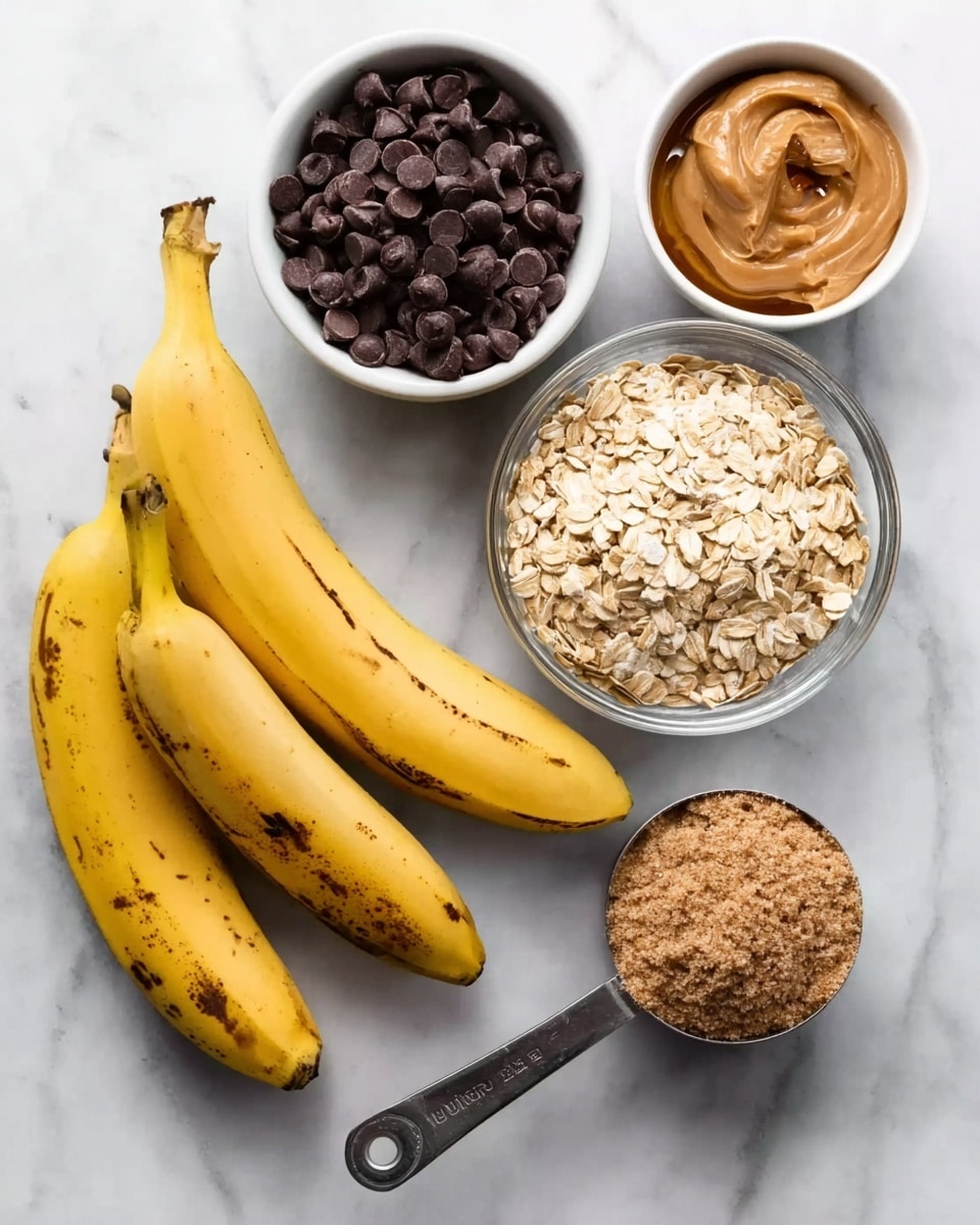 The image shows ingredients arranged neatly on a white marbled surface. There are two ripe yellow bananas with some brown spots placed at the bottom left. Above them, from left to right, there is a white bowl filled with dark chocolate chips, a smaller white bowl holding light brown honey, and a clear glass bowl filled with dry rolled oats, which displays its rough texture. In front of the bananas and bowls, there are two metal measuring cups: one cup is filled with smooth, creamy peanut butter, and the other holds a mound of light brown flaxseed meal. The items are spaced evenly, making each ingredient clearly visible. Photo taken with an iphone --ar 4:5 --v 7