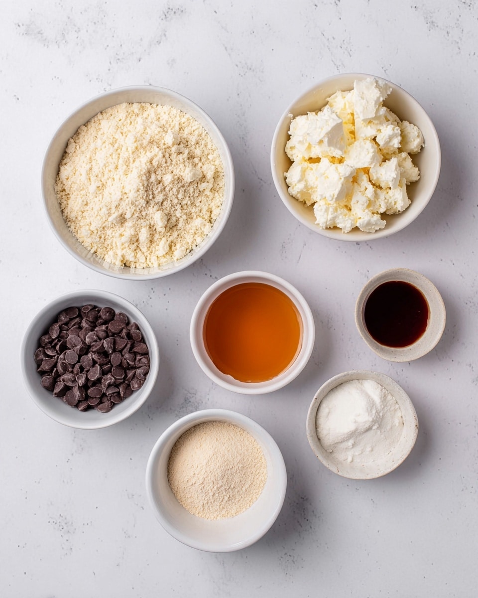 Six white bowls on a white marbled surface hold different ingredients. The top left bowl is filled with light beige powder with a crumbly texture. To the right of it, a smaller bowl contains smooth amber liquid. The top right bowl holds white chunky curds resembling cottage cheese. Below to the left, a small bowl contains dark brown chocolate chips. The middle bottom bowl has more pale beige powder, but finer than the first one. The bottom right bowl holds a small amount of dark amber syrup. Photo taken with an iphone --ar 4:5 --v 7