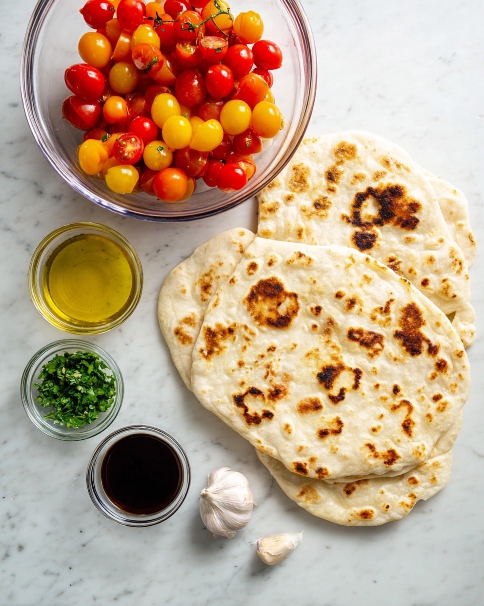 The image shows three flatbreads with brown toasted spots stacked loosely on the right side over a white marbled surface. On the left, there is a large clear glass bowl filled with halved red and yellow cherry tomatoes. Below the bowl are three small clear glass bowls, one with green chopped herbs, one with golden olive oil, and one with dark balsamic vinegar. A single garlic clove lies next to these small bowls, completing the arrangement. All items rest neatly against the white marbled background. photo taken with an iphone --ar 4:5 --v 7