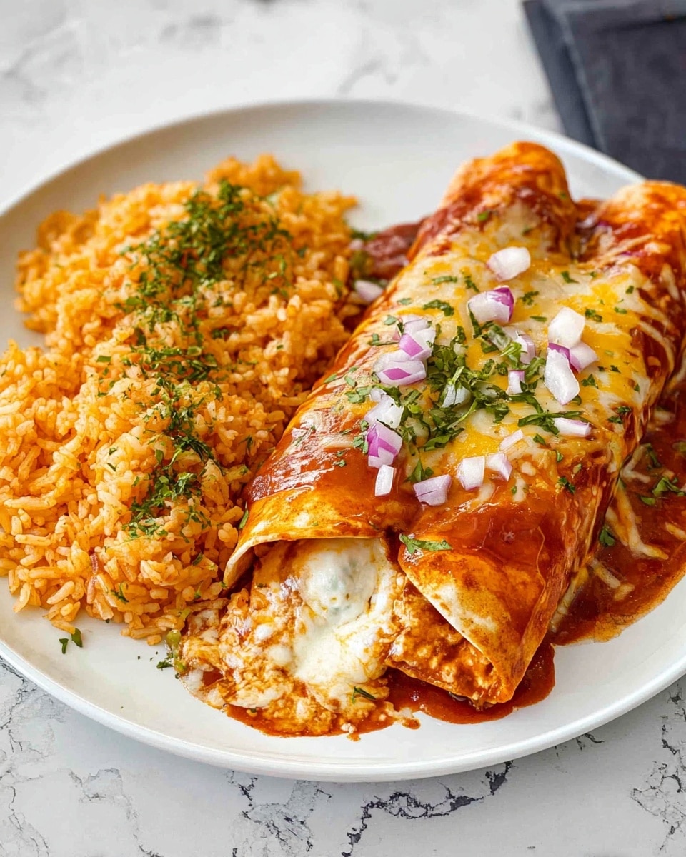 The image shows a white plate holding two rolled enchiladas covered in a rich, reddish-orange sauce with melted cheese on top. One of the enchiladas is open, revealing a creamy white filling inside. The enchiladas are garnished with small bits of purple onion and green herbs. To the side of the enchiladas is a serving of yellow-orange rice mixed with green herbs. The plate is set on a white marbled surface. Photo taken with an iphone --ar 4:5 --v 7