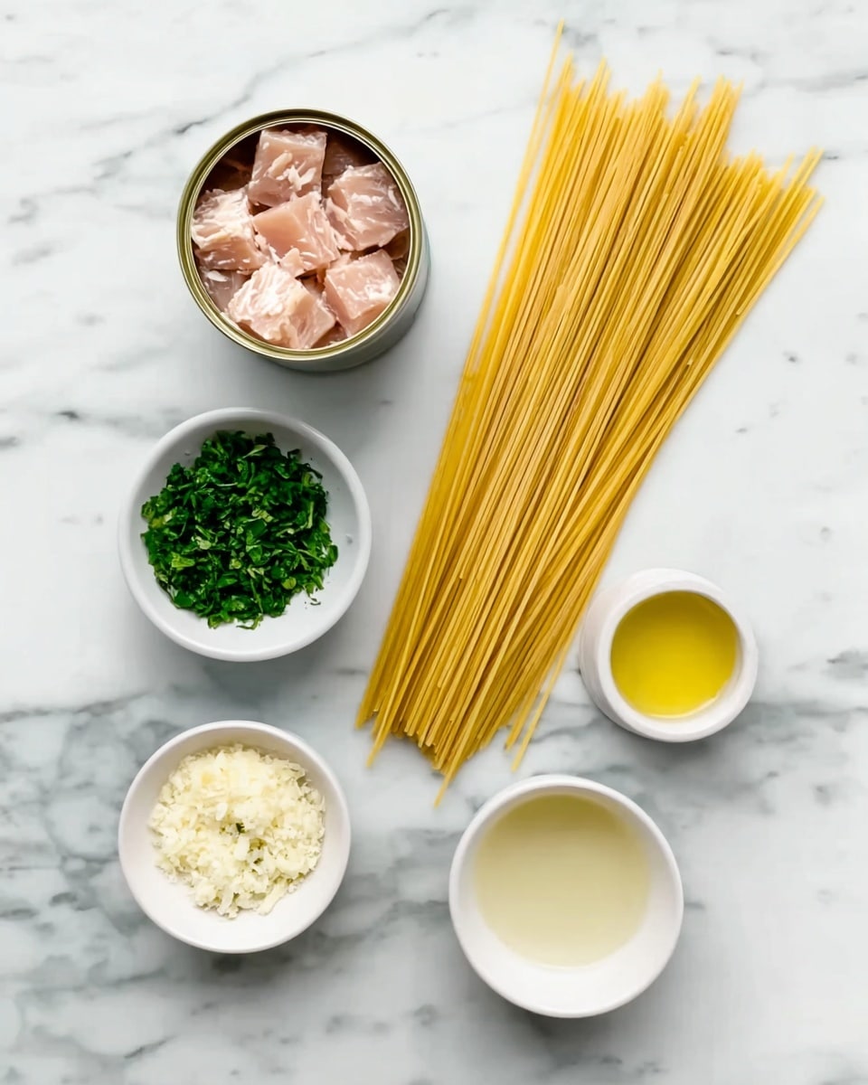A white marbled surface holds all the ingredients neatly arranged: a can opened to show pale pink tuna chunks in the top left, next to a straight bundle of pale yellow dry spaghetti on the right side. Below the tuna is a small white bowl with finely chopped fresh green parsley, and diagonally above it is a small white bowl filled with finely minced white garlic. Above the garlic is a small white bowl with golden olive oil, and below that on the right is another small white bowl holding a clear liquid, likely lemon juice. The scene is bright and clean with the ingredients spaced out evenly. photo taken with an iphone --ar 4:5 --v 7