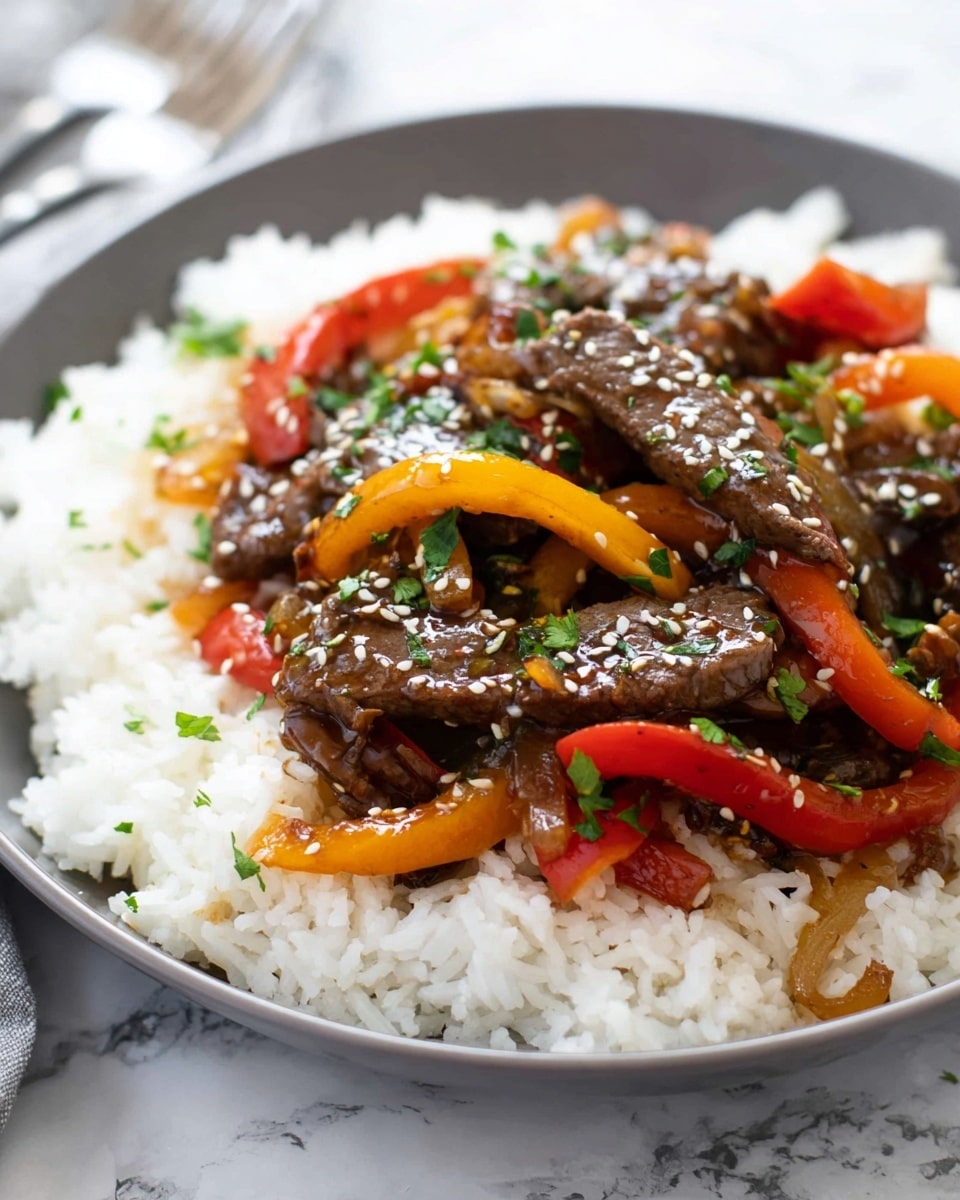A white round plate filled with a base layer of fluffy white rice covering the bottom. On top, there are several thin brown strips of cooked beef mixed with bright red and yellow bell pepper slices, along with some light brown onion pieces. The beef and vegetables are coated in a glossy dark sauce. The dish is sprinkled with white sesame seeds and chopped green herbs, adding texture and color contrast. The plate is set on a white marbled surface with a fork blurred in the background. photo taken with an iphone --ar 4:5 --v 7