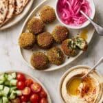 Baked Falafel Pitas with Hummus, Veggies, and Tahini Sauce Recipe