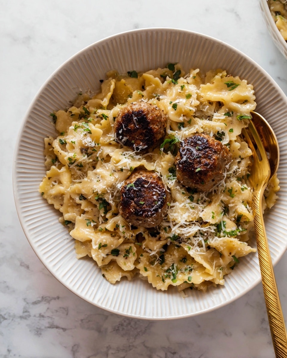 A white, round, ribbed bowl holds a pasta dish with three browned, round meatballs placed near the center. The pasta is wavy-edged, light golden with some parts slightly translucent, mixed with small green herbs scattered throughout and topped lightly with grated cheese. A golden fork is resting on the right side of the bowl. The bowl sits on a white marbled surface. photo taken with an iphone --ar 4:5 --v 7