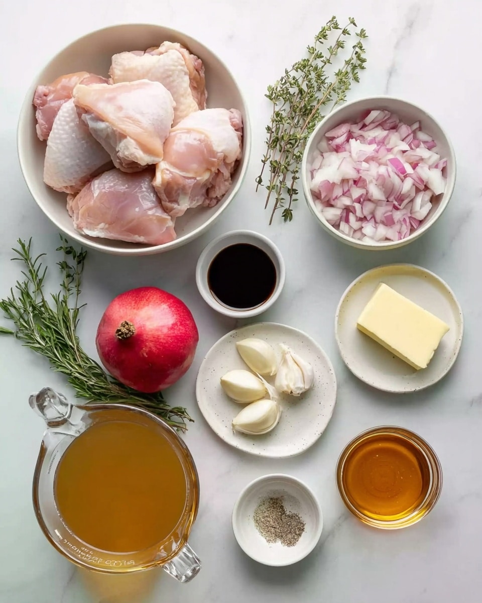 The image shows multiple ingredients placed separately on a white marbled surface. At the top left, there is a white bowl filled with raw, pale pink chicken thighs with skin. To the right, a white bowl contains chopped shallots, mostly light purple and white. Below the bowls, there are three garlic cloves arranged on the surface next to a small white bowl with dark soy sauce and another small white bowl with a yellowish mustard. Below that, there is a small white plate with black pepper and salt mixed on it, and nearby a small white bowl with a cube of pale yellow butter. There is a whole red pomegranate placed near a sprig of green herbs including rosemary and thyme. At the bottom left, there is a glass measuring cup filled with light brown broth, and to the right of it a small measure cup filled with amber honey. The overall layout is neat and bright. Photo taken with an iphone --ar 4:5 --v 7