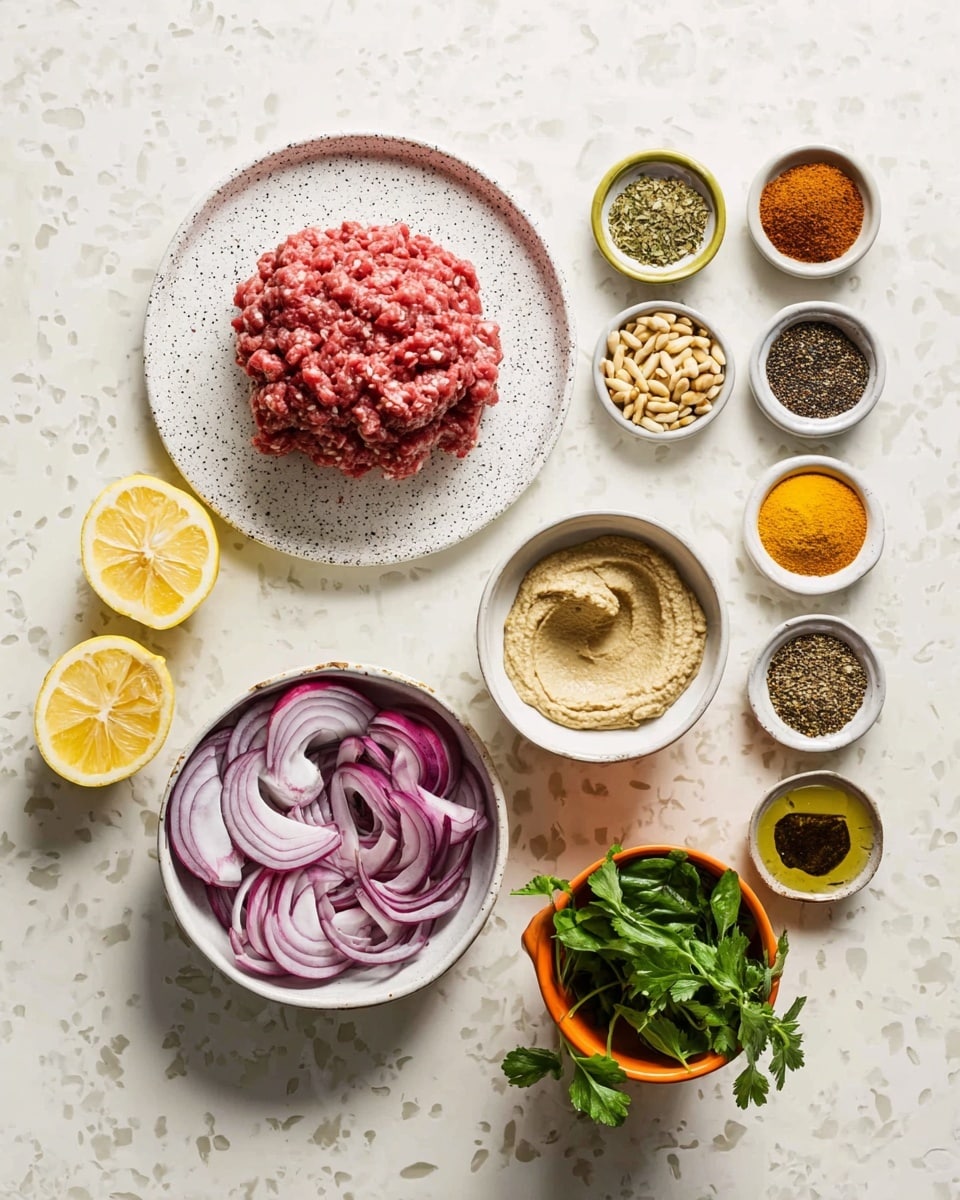 The image shows an arrangement of ingredients on a white marbled surface. In the center, there is a white speckled plate with a mound of raw, ground meat that is red with some white fat spots. Below it is a bowl filled with thinly sliced red onions that have a purple and white color with a glossy texture. Next to it, there is a bowl with a thick, creamy beige paste, likely hummus. Above the meat to the right, eleven small bowls and containers hold various spices and seasonings in colors like bright red, yellow, dark brown, and green. To the left of the meat, two lemon halves with bright yellow flesh rest on the surface. There is also a small white bowl with toasted pine nuts and an orange pot filled with fresh green herbs such as parsley and basil. The whole setup is neat and colorful, creating a natural and fresh look for cooking photo taken with an iphone --ar 4:5 --v 7