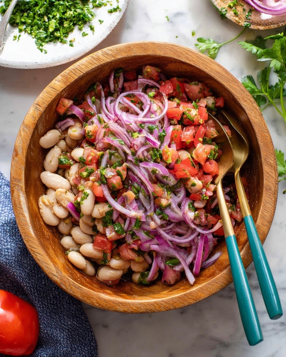 A wooden bowl filled with a colorful salad made of three main layers: the bottom layer has large white beans scattered throughout, the middle layer contains thin strips of bright purple-red onions, and the top layer shows diced red tomatoes mixed with finely chopped green herbs all evenly mixed together. Two teal and gold spoons rest inside the bowl. The bowl is on a white marbled surface with some green parsley leaves and a whole red tomato nearby. A white plate with chopped green herbs sits in the background. photo taken with an iphone --ar 4:5 --v 7