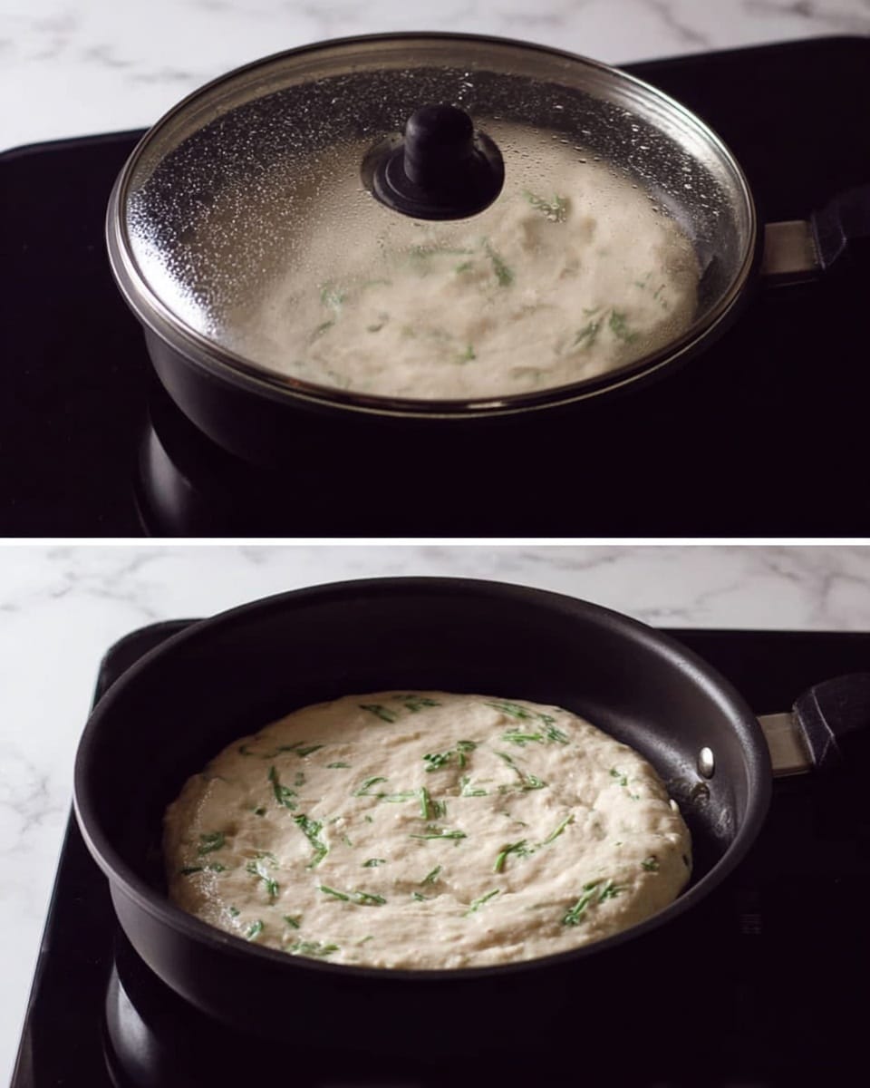 The image shows a close-up of a dark cooking pan on a black stovetop with a white marbled surface in the background. In the first part, a clear lid with droplets covers a pale, round, thick pancake-like batter with small green herb pieces spread evenly across the surface, cooking inside the pan. In the second part, the lid is removed, revealing the pale batter with a slightly textured surface and visible green herbs, still uncooked on top but firm around the edges, filling the pan evenly. photo taken with an iphone --ar 4:5 --v 7