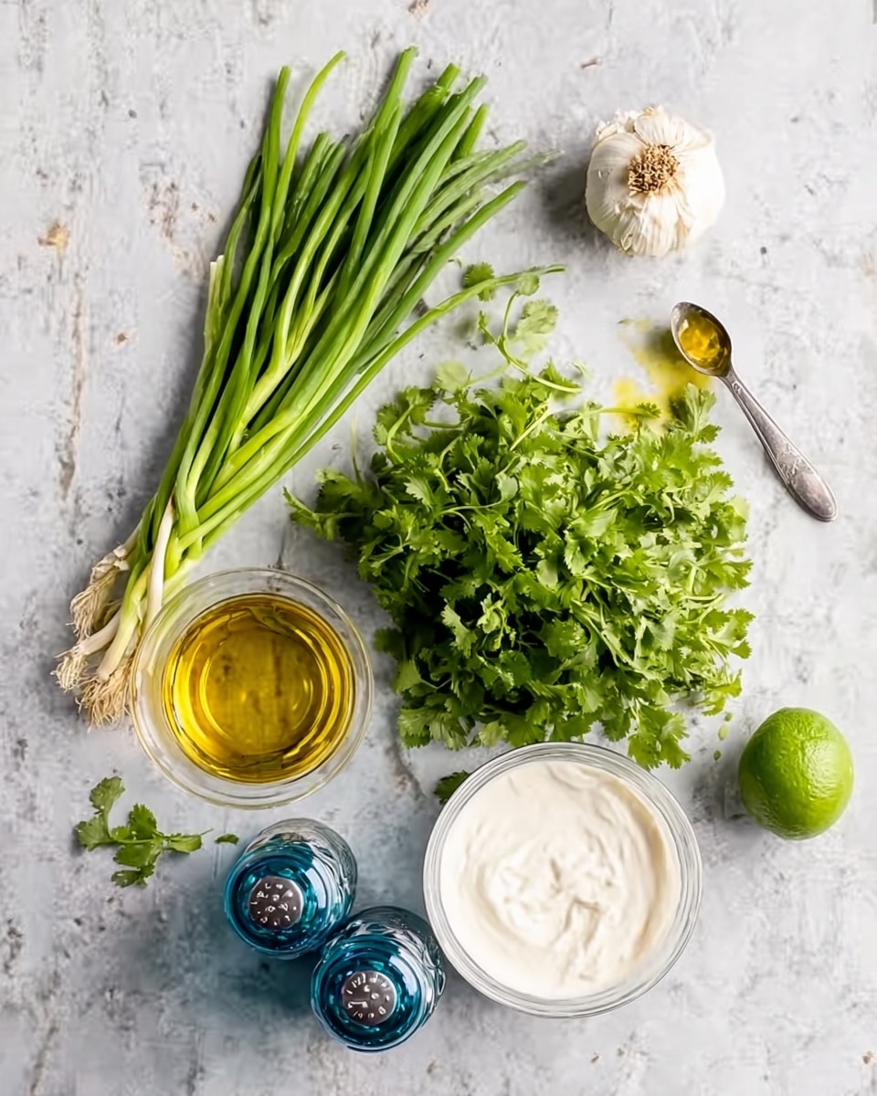 The image shows fresh cooking ingredients arranged on a white marbled surface. There is a bunch of green onions with long green stalks and white bulbs on the left side, beside a cluster of bright green cilantro leaves with stems. Above them is a whole garlic bulb with a white and slightly brownish top. Near the bottom left, there is a clear glass bowl filled with golden oil, and next to it are two blue and transparent salt and pepper grinders. A white bowl with smooth, creamy white yogurt or sauce is placed toward the bottom right. A small green lime is near the cilantro, and a spoon with a bit of yellow oil rests on the upper right area. The photo taken with an iphone --ar 4:5 --v 7